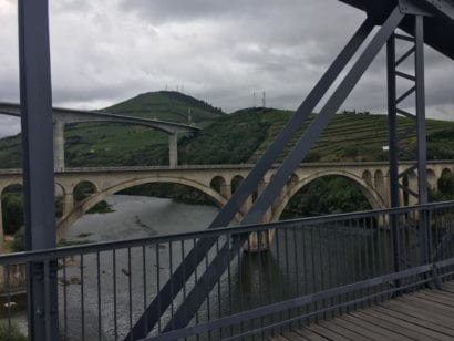 Bridge crossing river that goes between Portugal hills