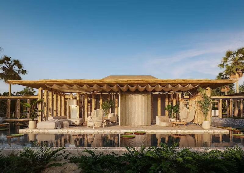 Six Senses Grand Bahama open-air lounge pavilion with bamboo structure, poolside seating, and tropical garden