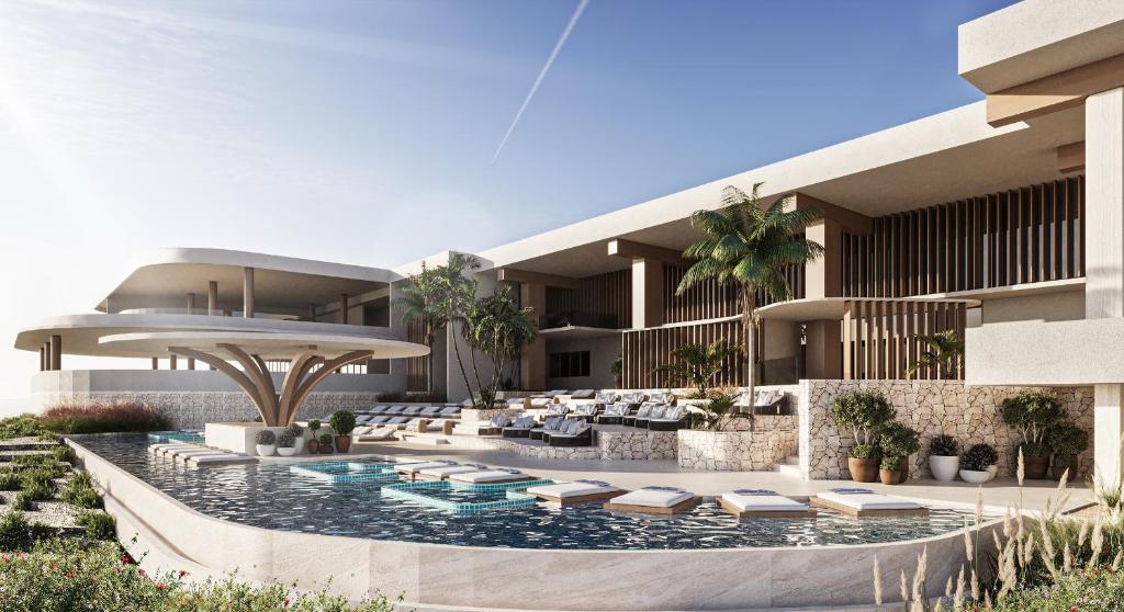 TUI BLUE Curaçao resort pool area with floating sun loungers, sculptural shade structure, and modern stone facade